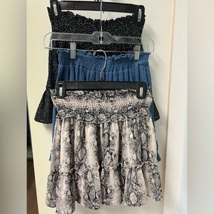 This is a lot of three mini ruffled skirts: blue, animal print and black/white.